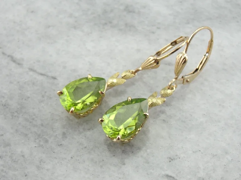 Ladies earrings diamond accent pieces-Perfect Green Drops: Peridot Drop Earrings with Leaf Motif Accent